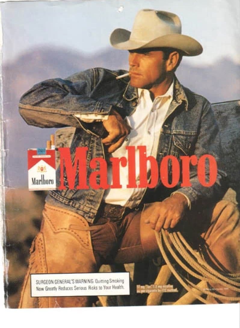Marlboro ad with seated cowboy.